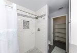 Step-in tiled shower with a private closet